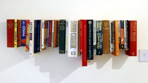 Books on hanging shelf.designblog