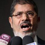 SHOWDOWN: Deposed Egyptian president Morsi of Muslim Brotherhood on trial; Death penalty, life sentence possible