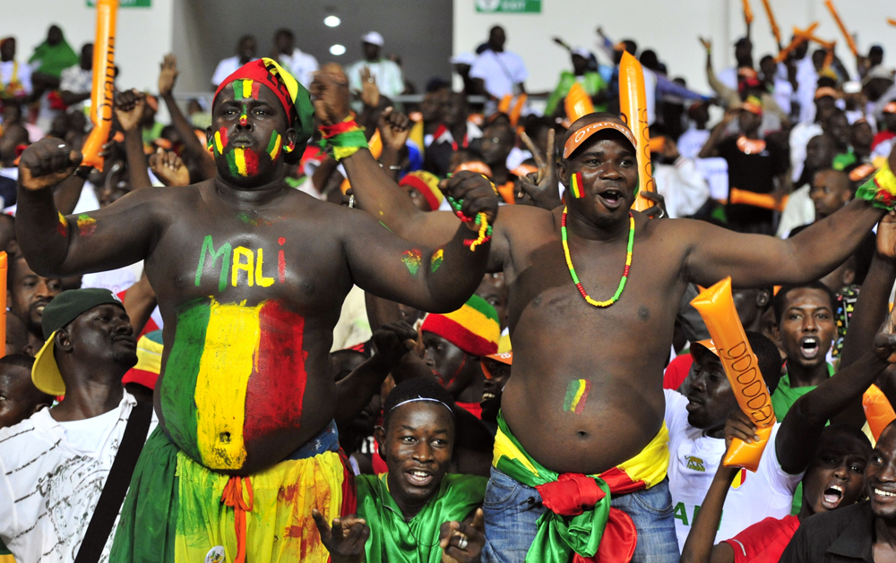 Supporters of the Malian national football team cheer up their team at the Stade de l'Amitie in Libreville on February 8, 2012 during their Africa Cup of Nations (CAN 2012) semi-final football match between Ivory Coast and Mali.     AFP PHOTO/ ISSOUF SANOGO (Photo credit should read ISSOUF SANOGO/AFP/Getty Images)