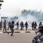 Nigeria protesters turn sideways as police fire shots and tear gas