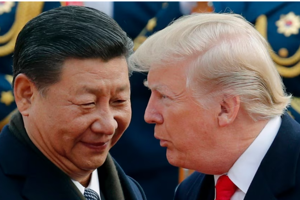 US President Donald Trump chats with Chinese President Xi Jinping during a welcome ceremony at the Great Hall of the People in Beijing on Nov. 9, 2017.