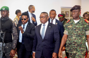Sierra Leone's President Julius Maada Bio, who chairs the Economic Community of West African States (ECOWAS), walks with Guinea-Bissau's transitional president Major-General Horta Inta-a during a meeting in Bissau, Guinea-Bissau December 1, 2025.